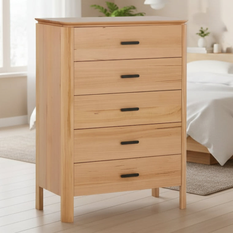 Wooden dresser with four drawers on a white background
