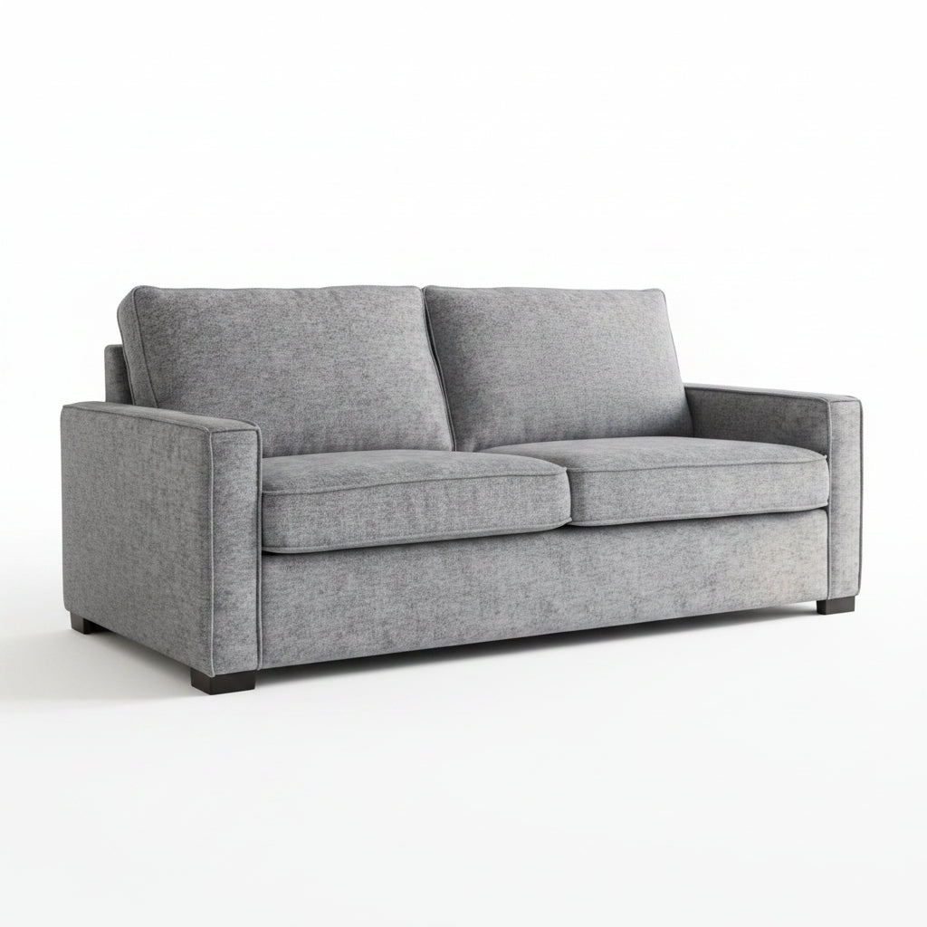 Gray sofa in a living room with abstract art on the wall and a plant.