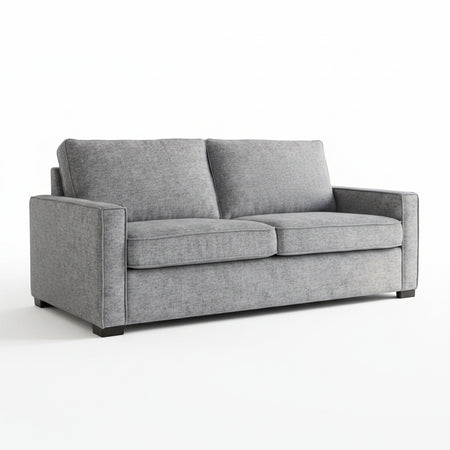 Gray sofa in a living room with abstract art on the wall and a plant.