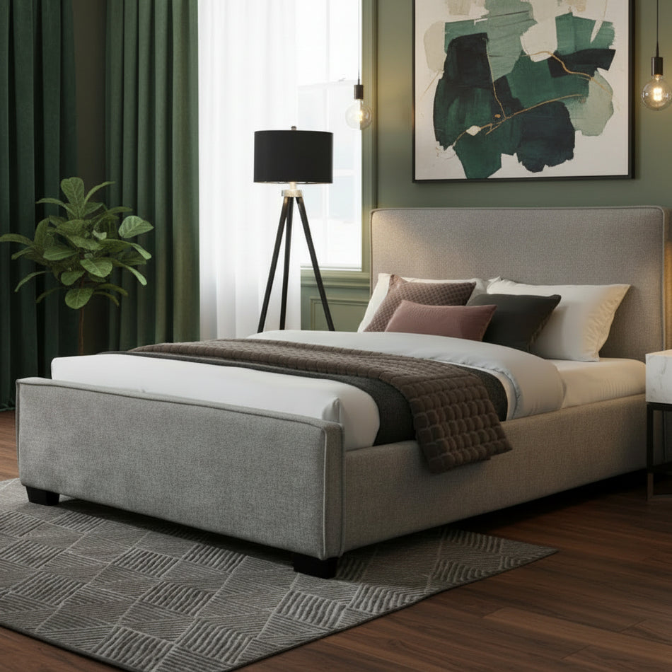 Gray upholstered bed in a modern bedroom with decor elements.