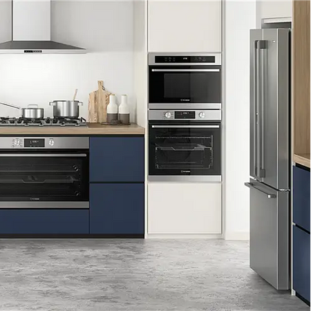 Modern kitchen with stainless steel appliances including a refrigerator, oven, and stove.