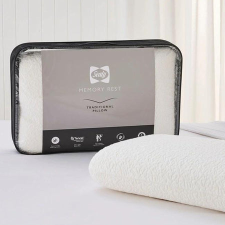 Memory foam pillow in packaging on a white surface with a neutral background