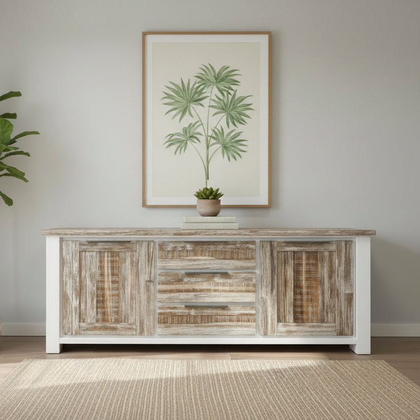 Wooden sideboard with decorative items and a framed beach scene on a wall.