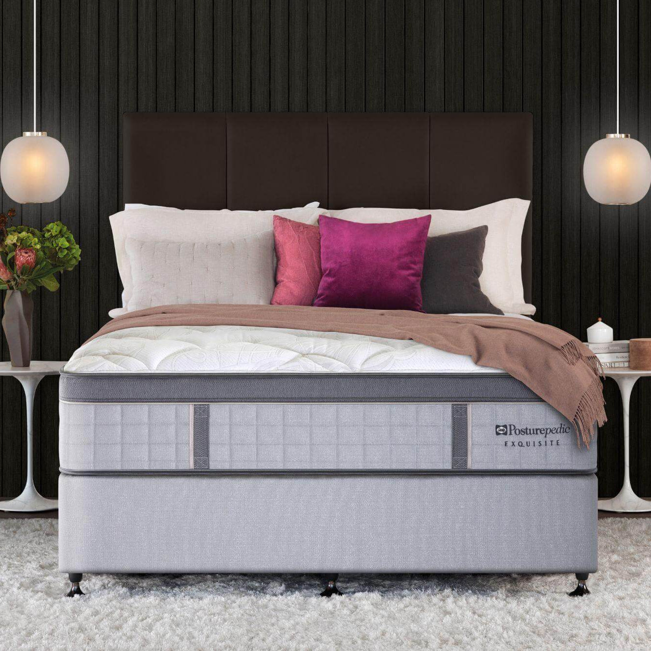 Gray mattress on a bed with pillows and a blanket in a bedroom setting.