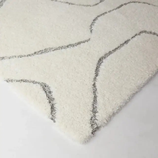 Textured rug with wavy pattern on a light background