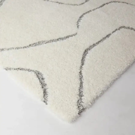 Textured rug with wavy pattern on a light background