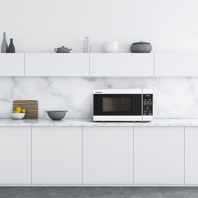 Modern kitchen with white cabinets, marble backsplash, and a microwave.