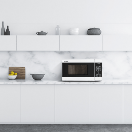 Modern kitchen with white cabinets, marble backsplash, and a microwave.