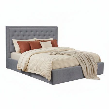 Gray upholstered bed with white bedding on a white background