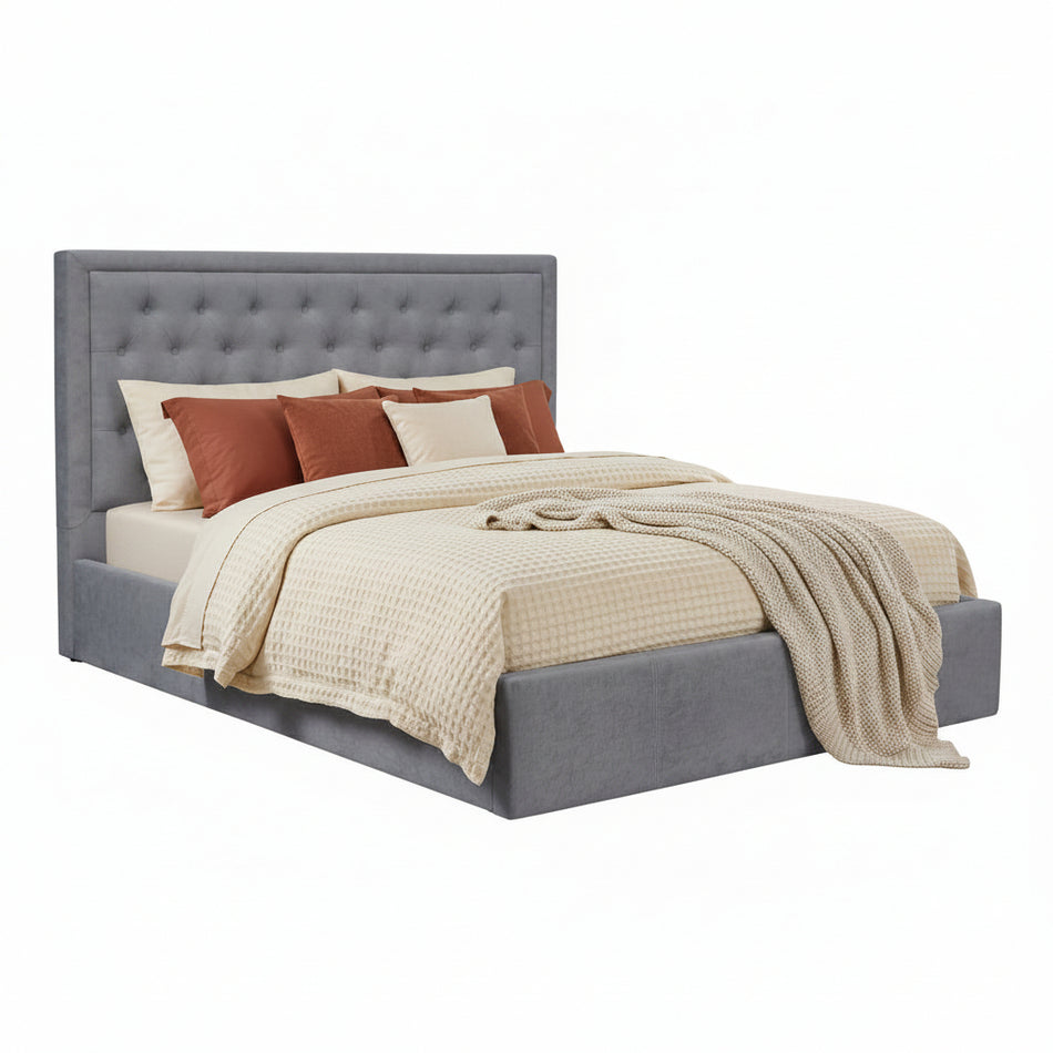 Gray upholstered bed with white bedding on a white background