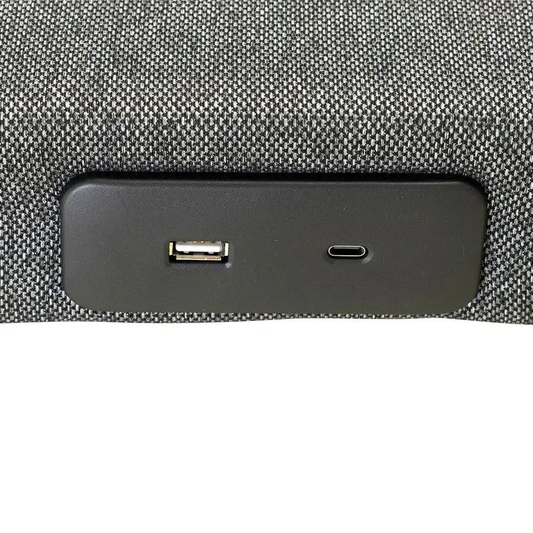 Close-up of a car dashboard with USB and charging port on a textured gray background