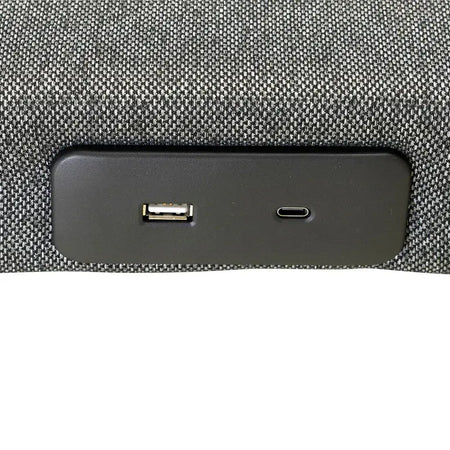 Close-up of a car dashboard with USB and charging port on a textured gray background