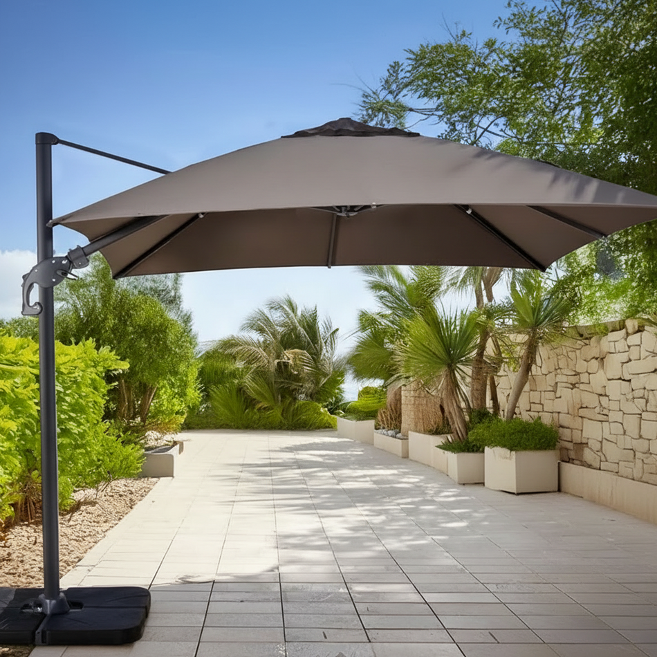 Laredo square cantilever umbrella in an outdoor setting with trees and a clear sky.