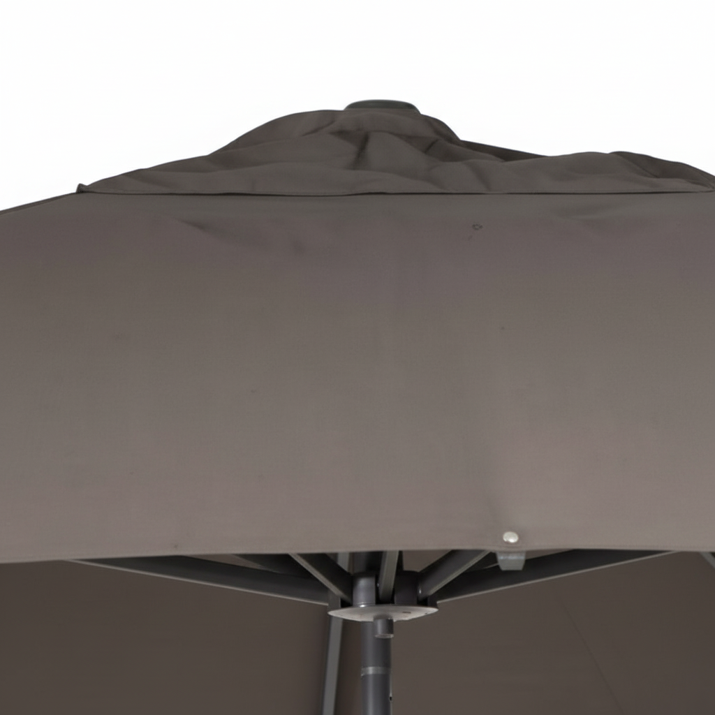 Close-up of a brown patio umbrella with visible wear and tear.