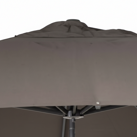 Close-up of a brown patio umbrella with visible wear and tear.