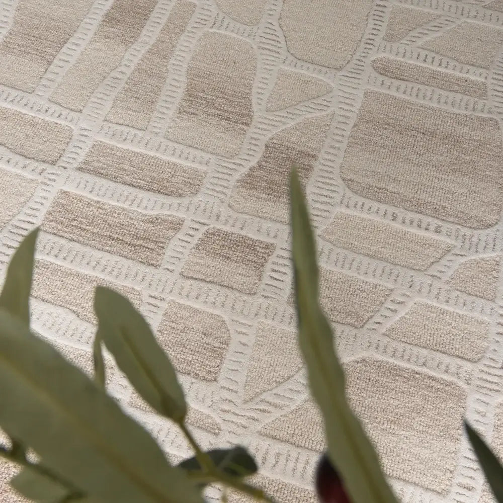 Close-up of a textured beige fabric with geometric pattern