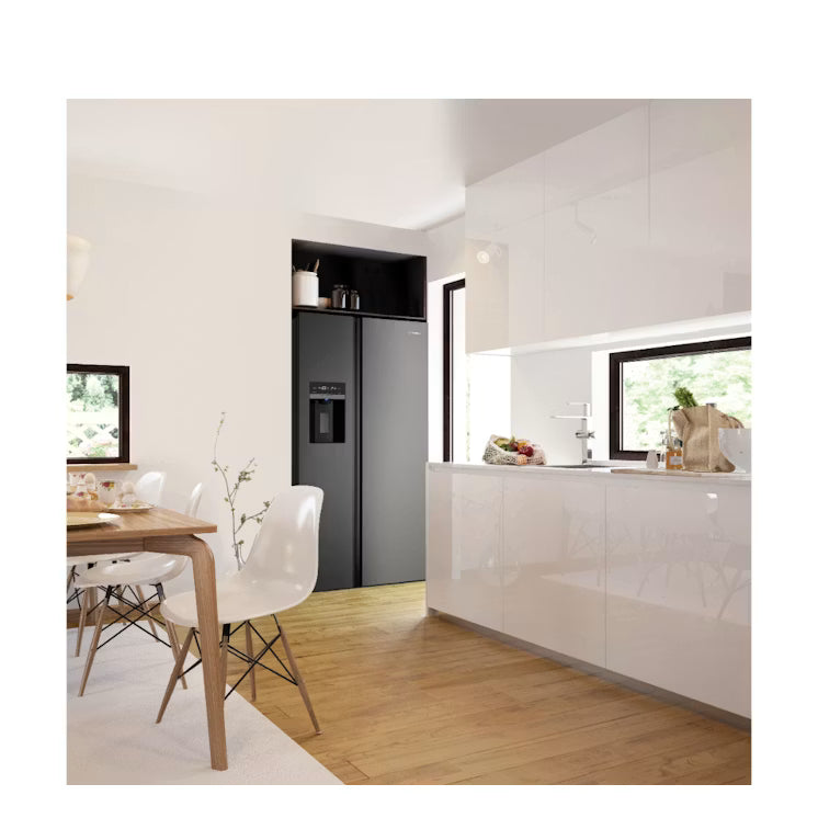 Modern kitchen with white cabinets, wooden floor, and dining area.