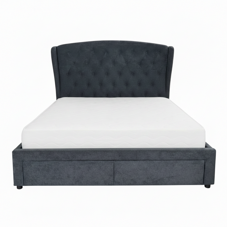 Gray upholstered bed with light blue diamond patterned comforter and pillows on a white background