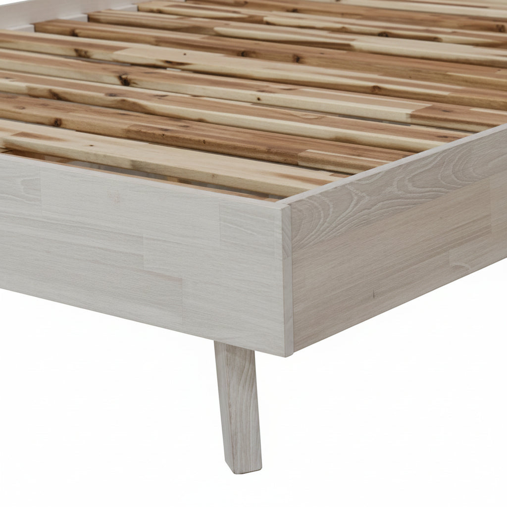 Wooden bed frame with slatted design on a white background