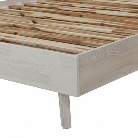 Wooden bed frame with slatted design on a white background