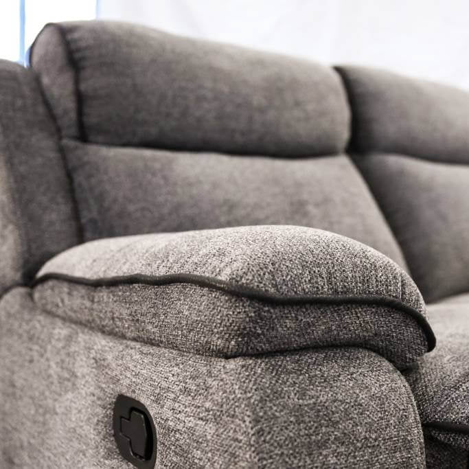 Gray fabric recliner sofa with a blurred background