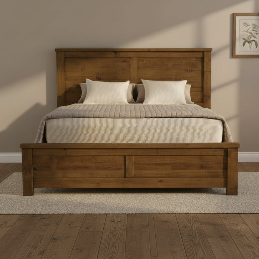 Wooden bed with a headboard and bedding on a white background