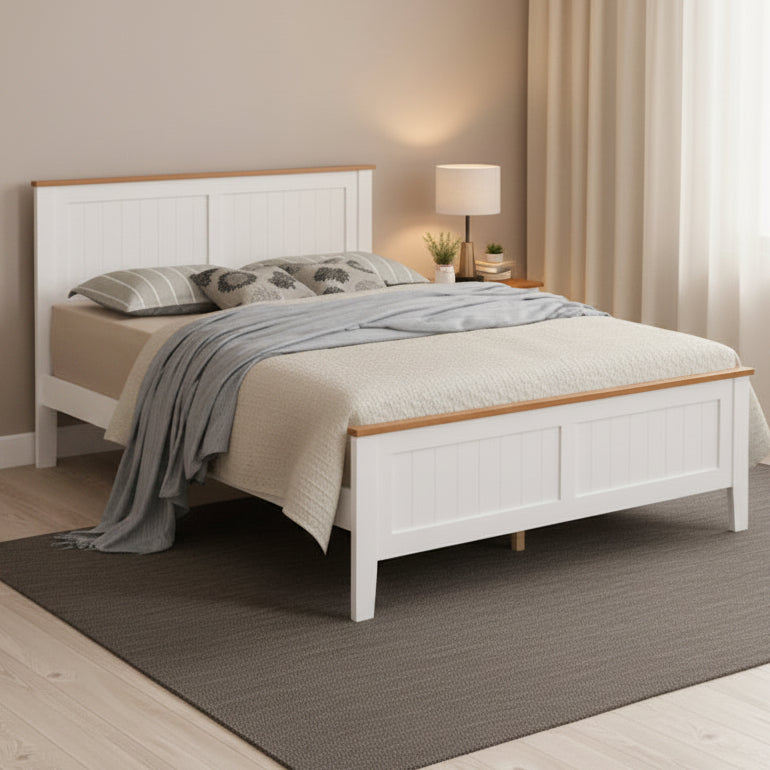 Bedroom with white bed and dresser against a beige wall.