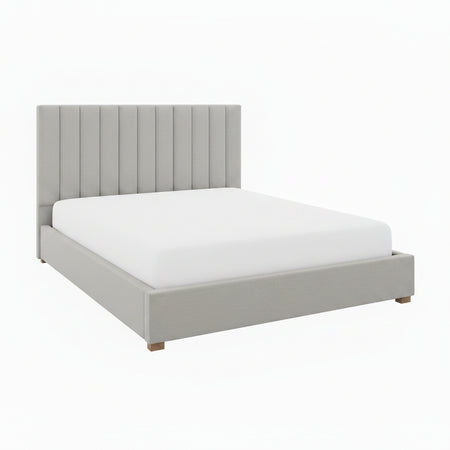 Gray upholstered bed with white bedding and decorative pillows in a bedroom setting.