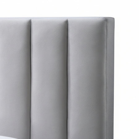Gray upholstered headboard with tufted design against a white wall
