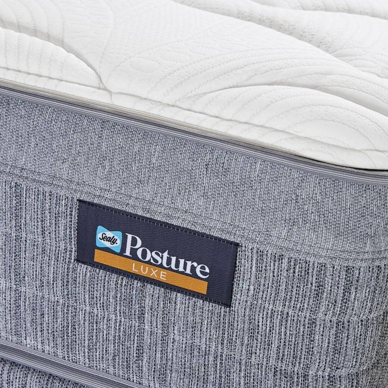 Gray mattress with a 'Serta Posture Luxe' label on a white background