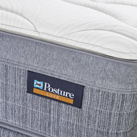 Gray mattress with a 'Serta Posture Luxe' label on a white background